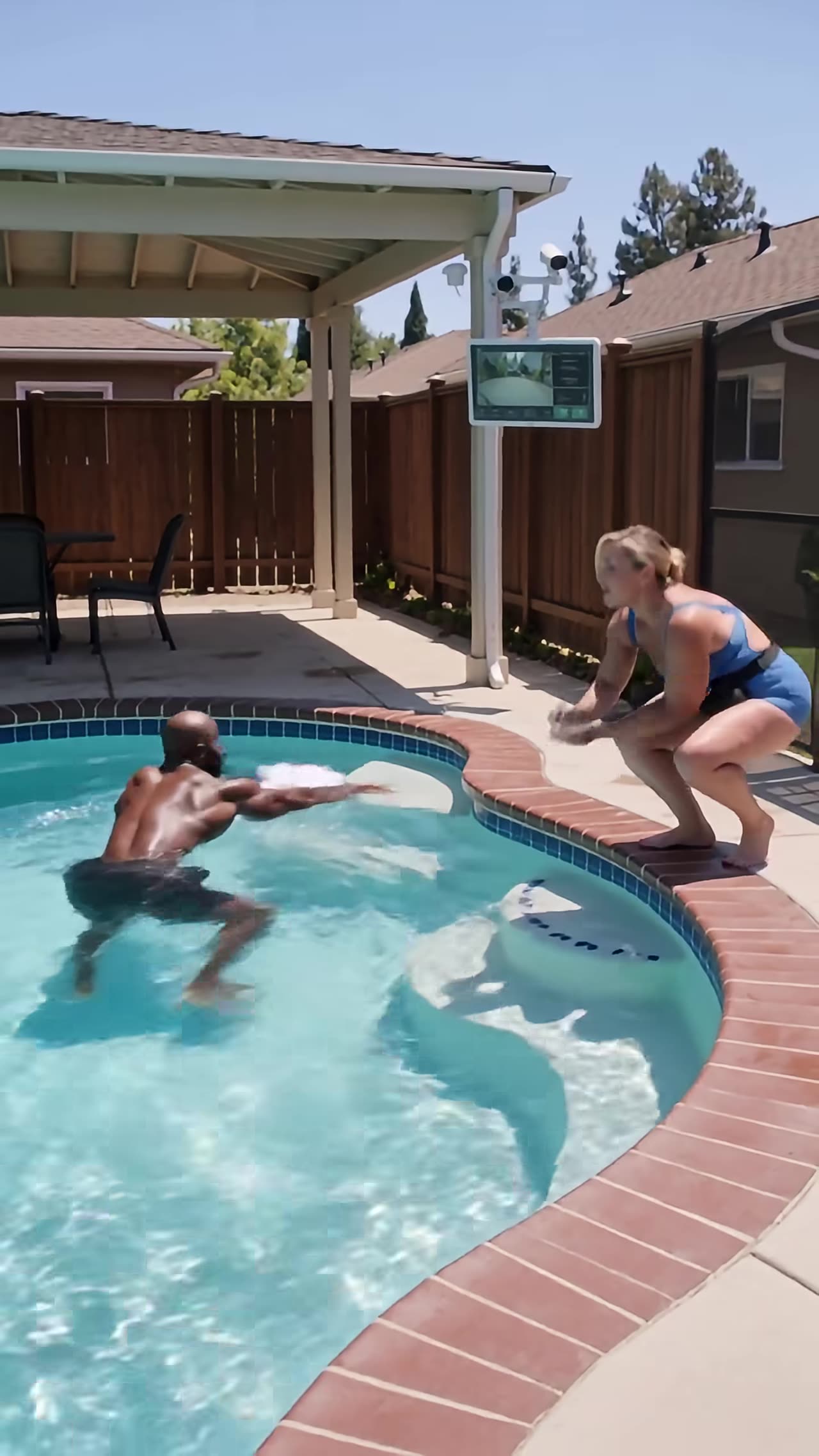 Woman crouching at pool edge confronting homeowner in the water