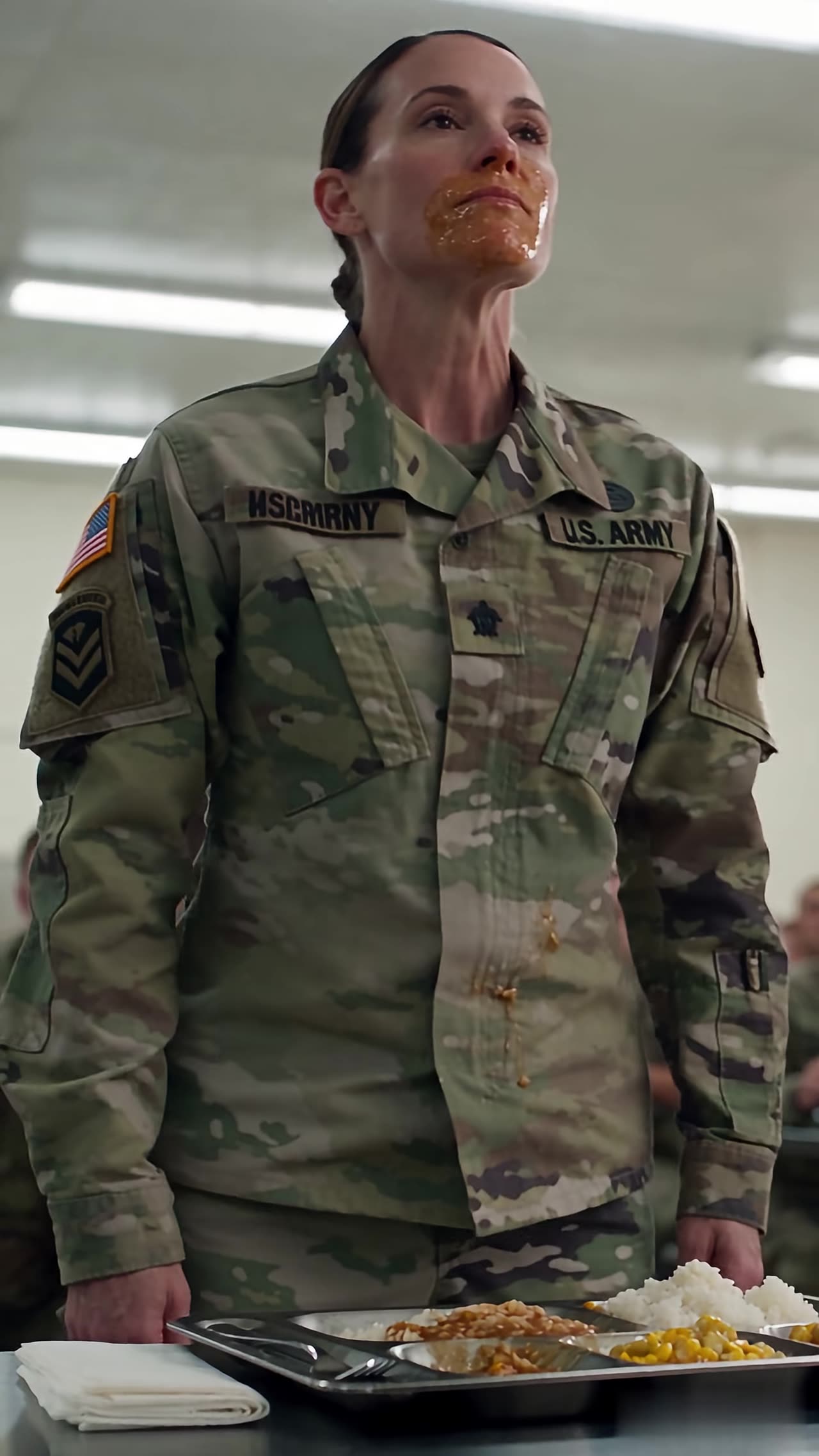 Female soldier standing with gravy covering her face