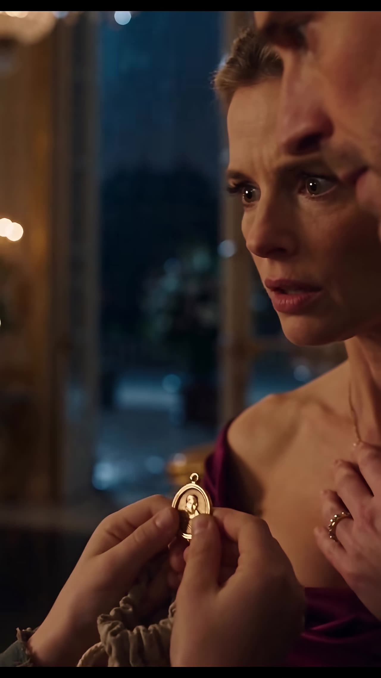 Close-up of locket as woman stares in disbelief at warning