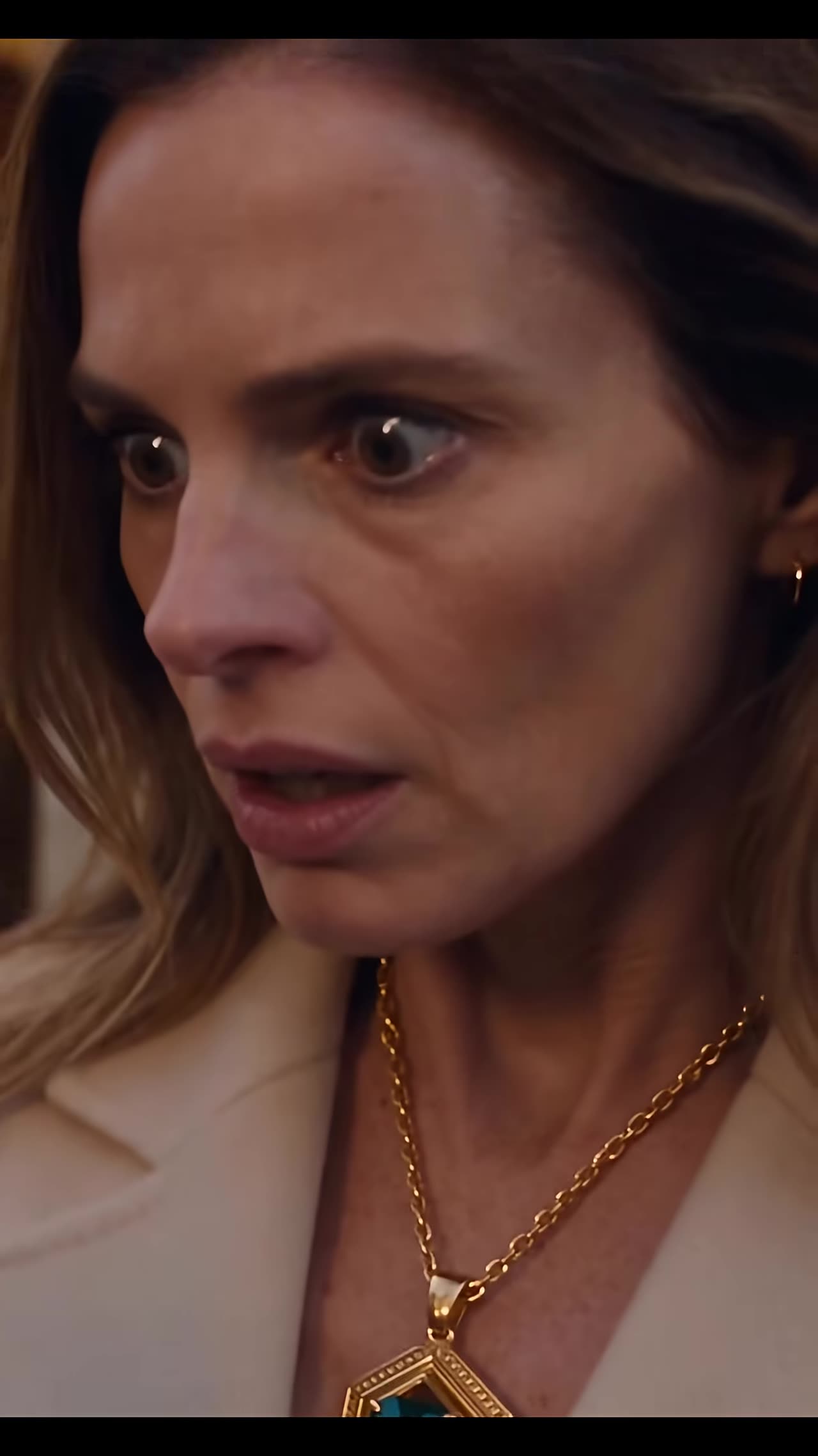 Shocked close-up of Victoria staring at twin emerald