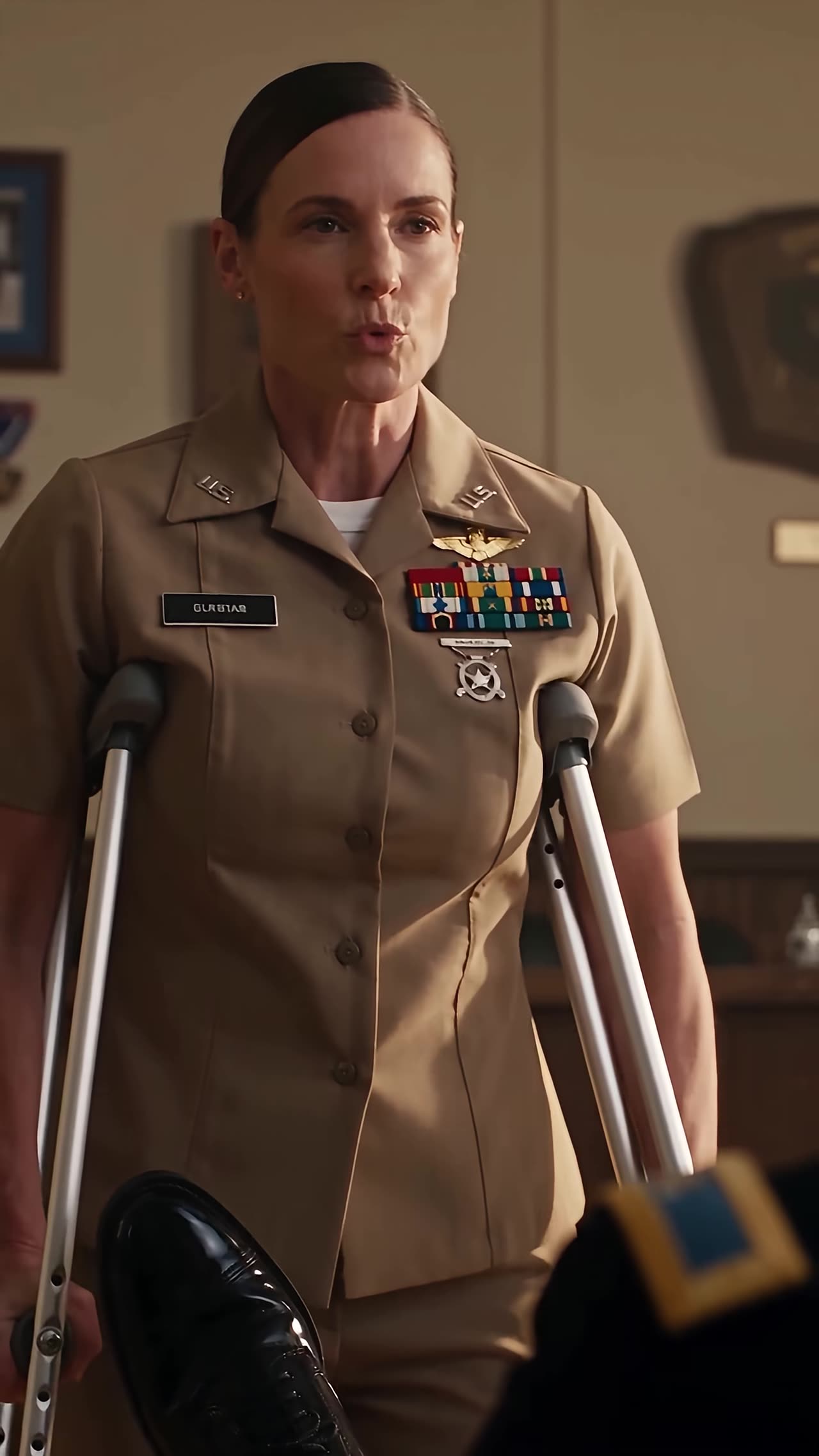 Captain Claire on crutches confronting Major Grant's blocking boot