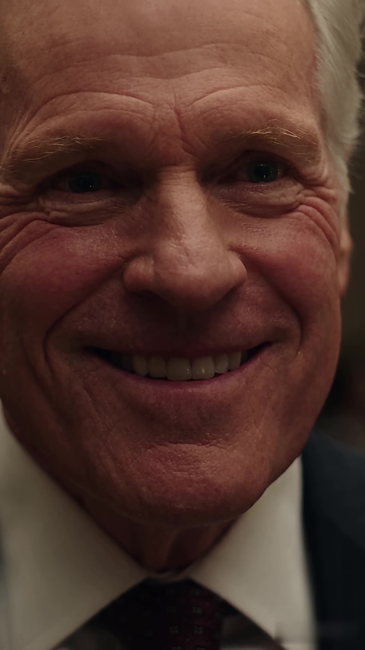 Close-up of smug father smiling before the shocking reveal