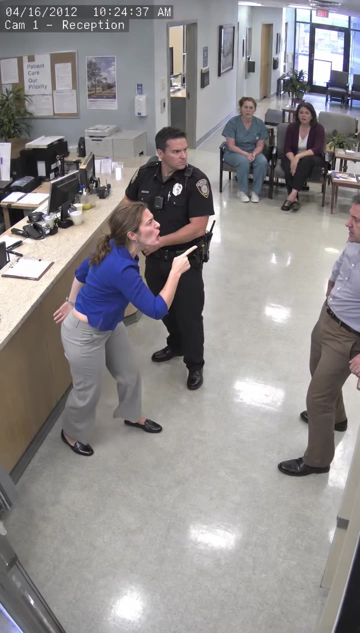Handcuffed woman points and shouts back at boyfriend before stunned witnesses