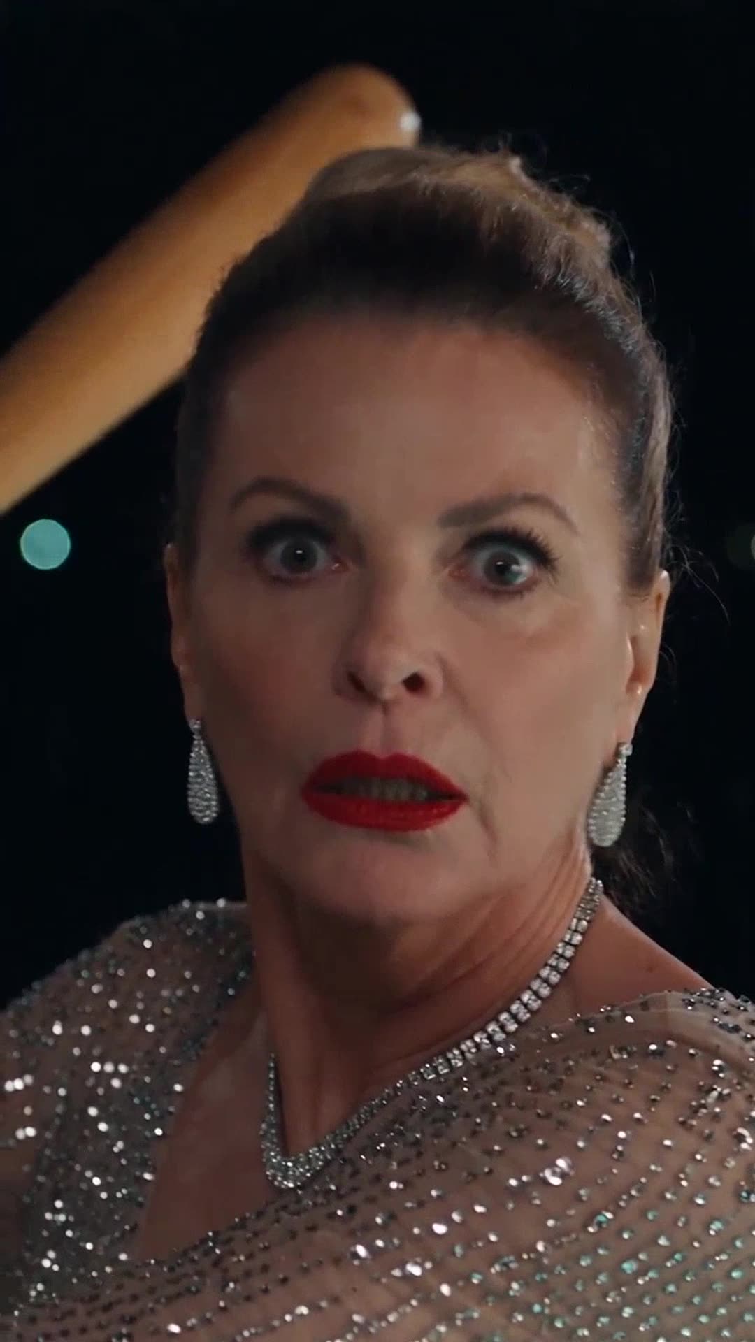 Close-up of Éléonore frozen in wide-eyed shock as headlights illuminate her